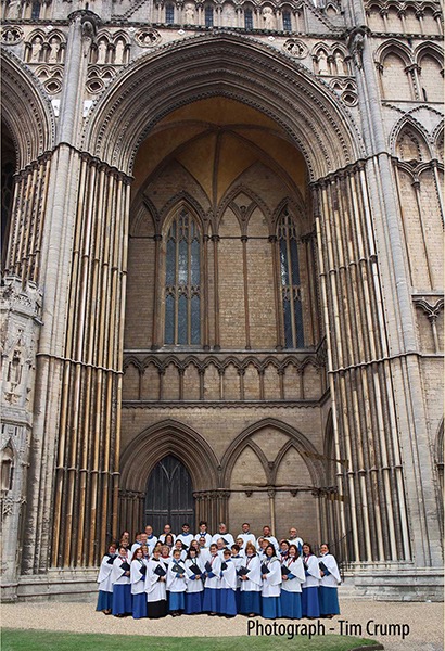 Sanderstead Singers in robes in front of the west front of Peterborough Cathedral